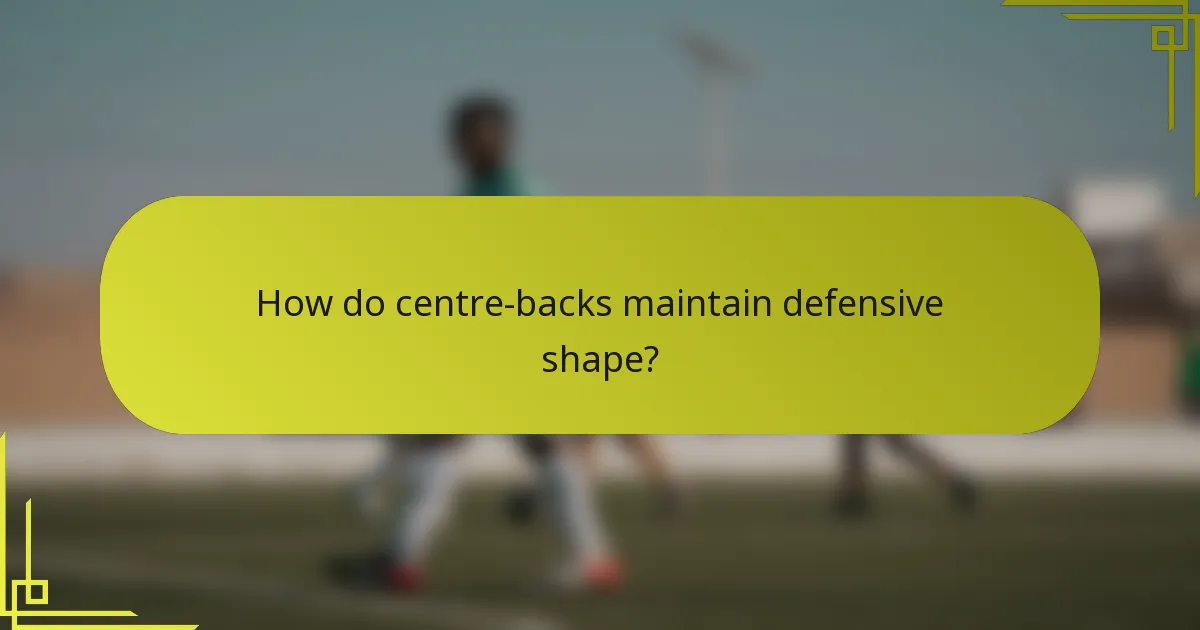 How do centre-backs maintain defensive shape?